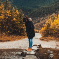 woman stepping stones