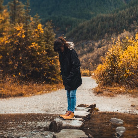 woman stepping stones